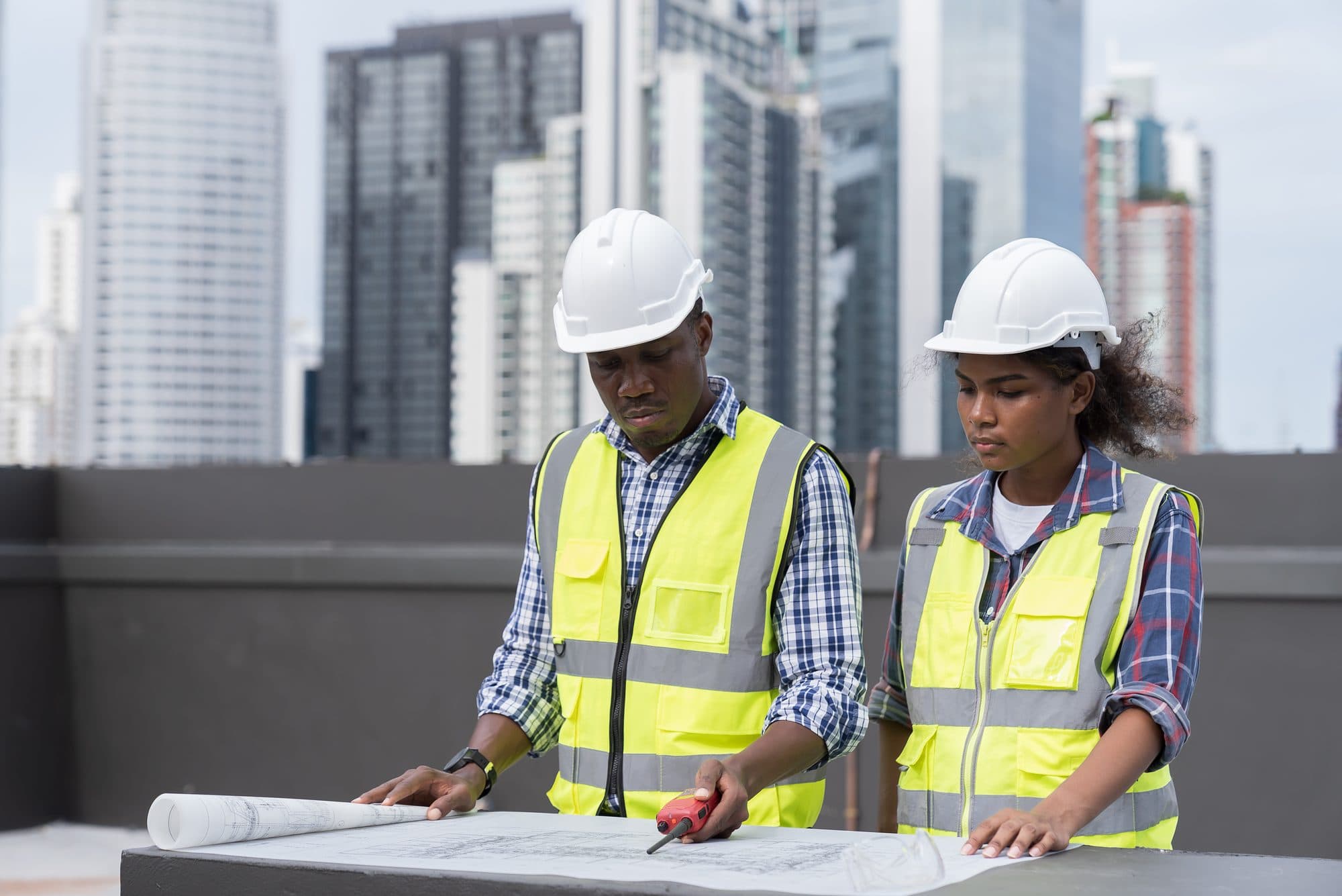 Engineers reviewing project blueprints on site