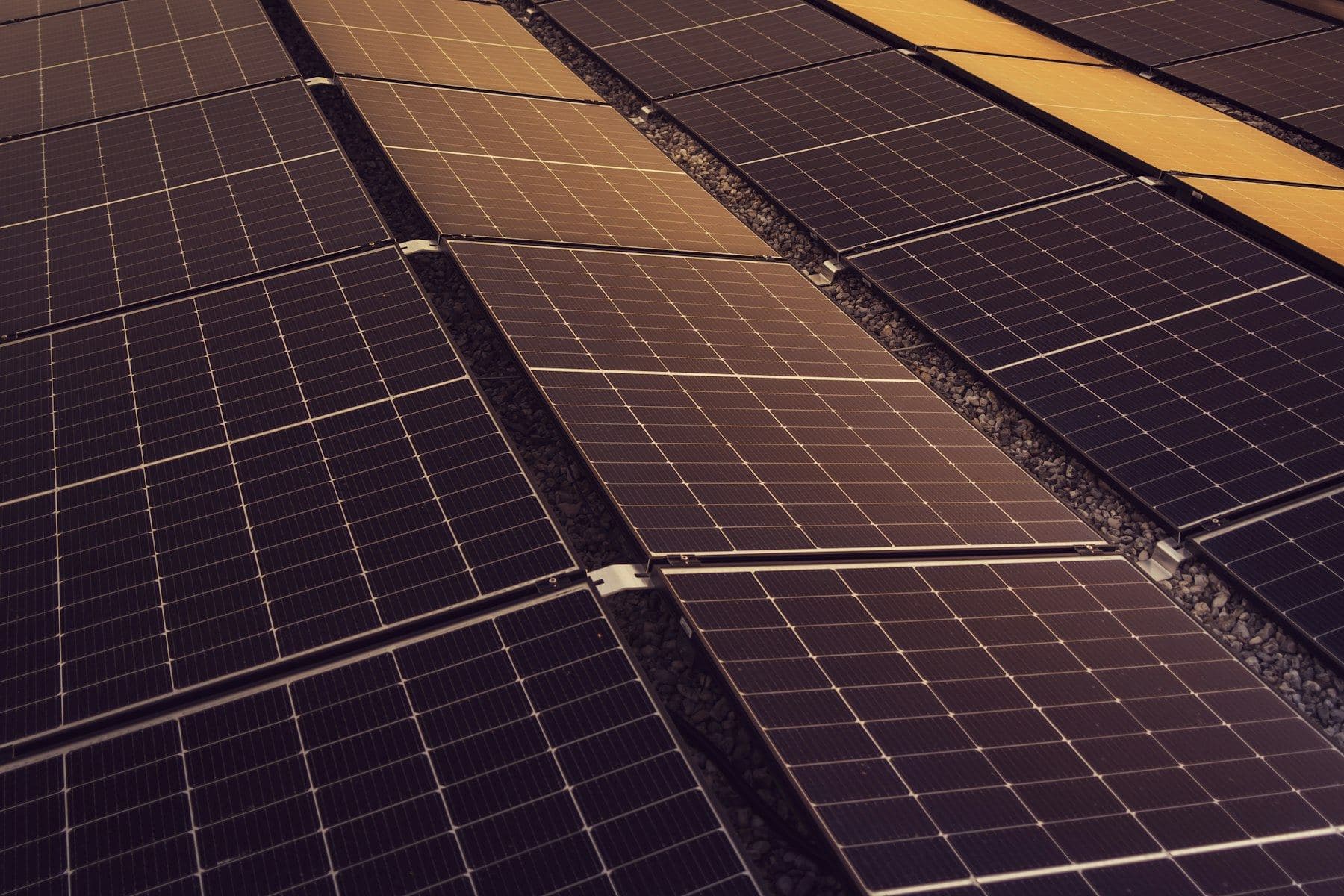 Technicians installing a solar panel array on a rooftop