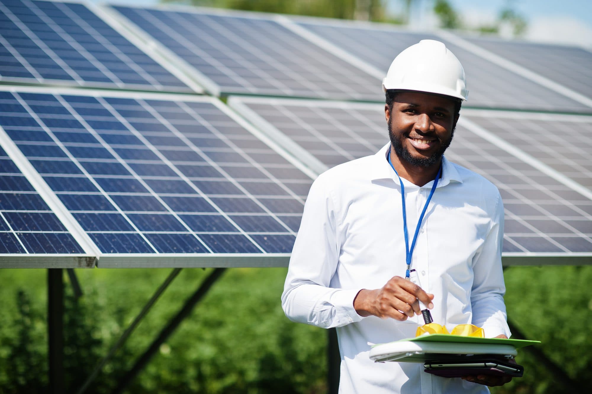 Technicians installing a solar panel array on a rooftop